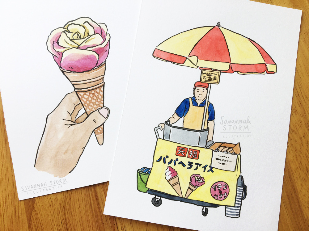 Two paintings on sheets of white paper laid on a table next to each other. One is a painting of a hand holding a pink and yellow ice cream, the other is an ice cream stand with an umbrella, and a lady smiling from behind the stand.