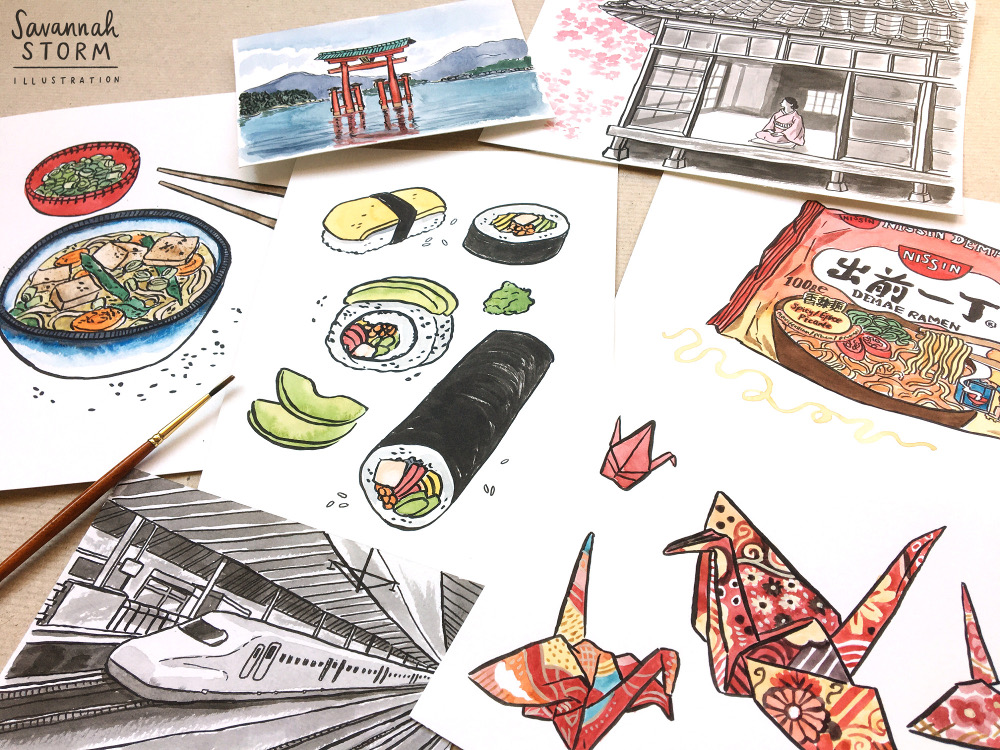 Several paintings lay scattered across a table, including drawings of a bowl of ramen, some sushi, some origami cranes, a bullet train, a tori gate shrine and a Japanese style house.