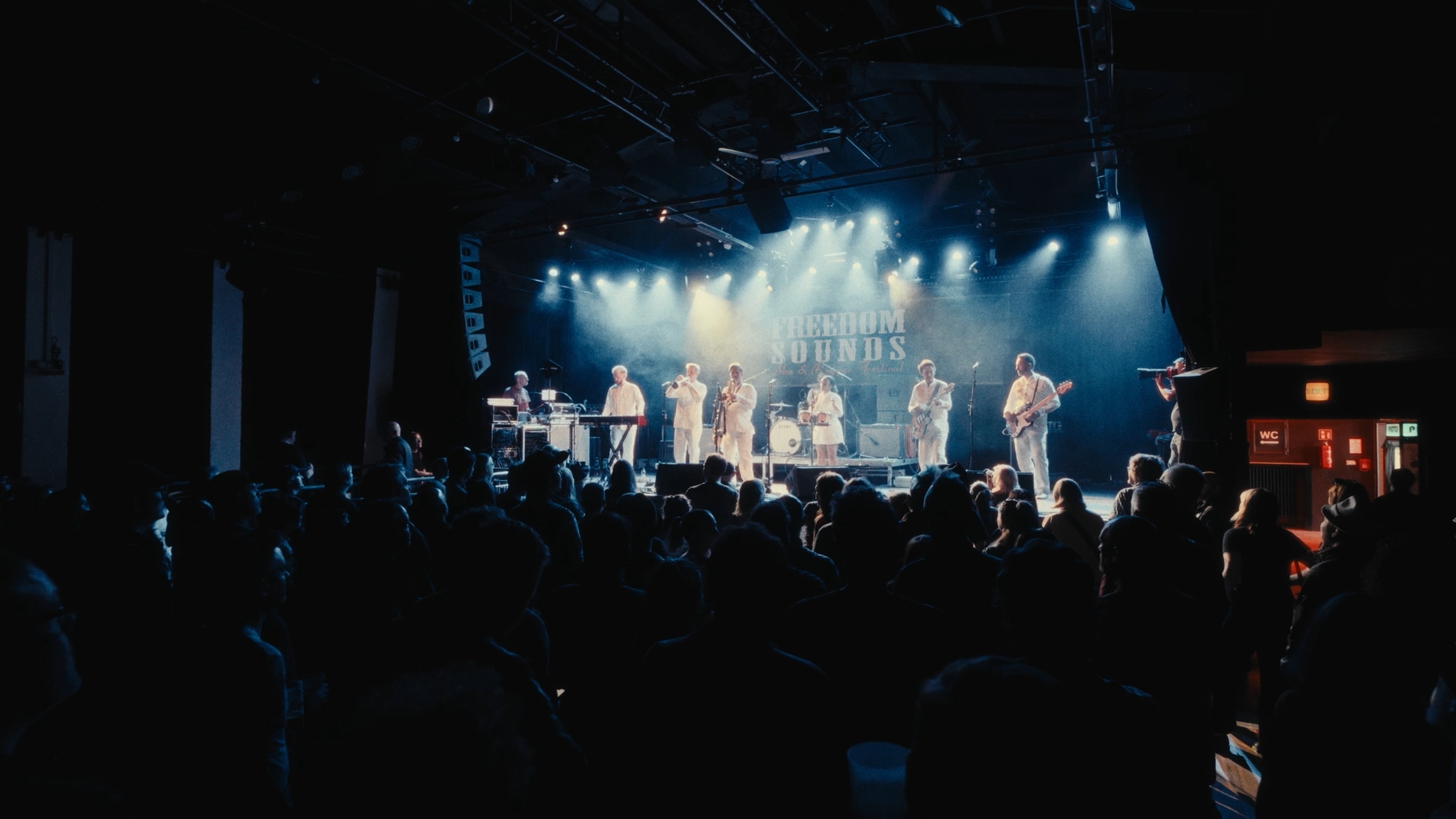 Festival stage and audience in blue concert lighting