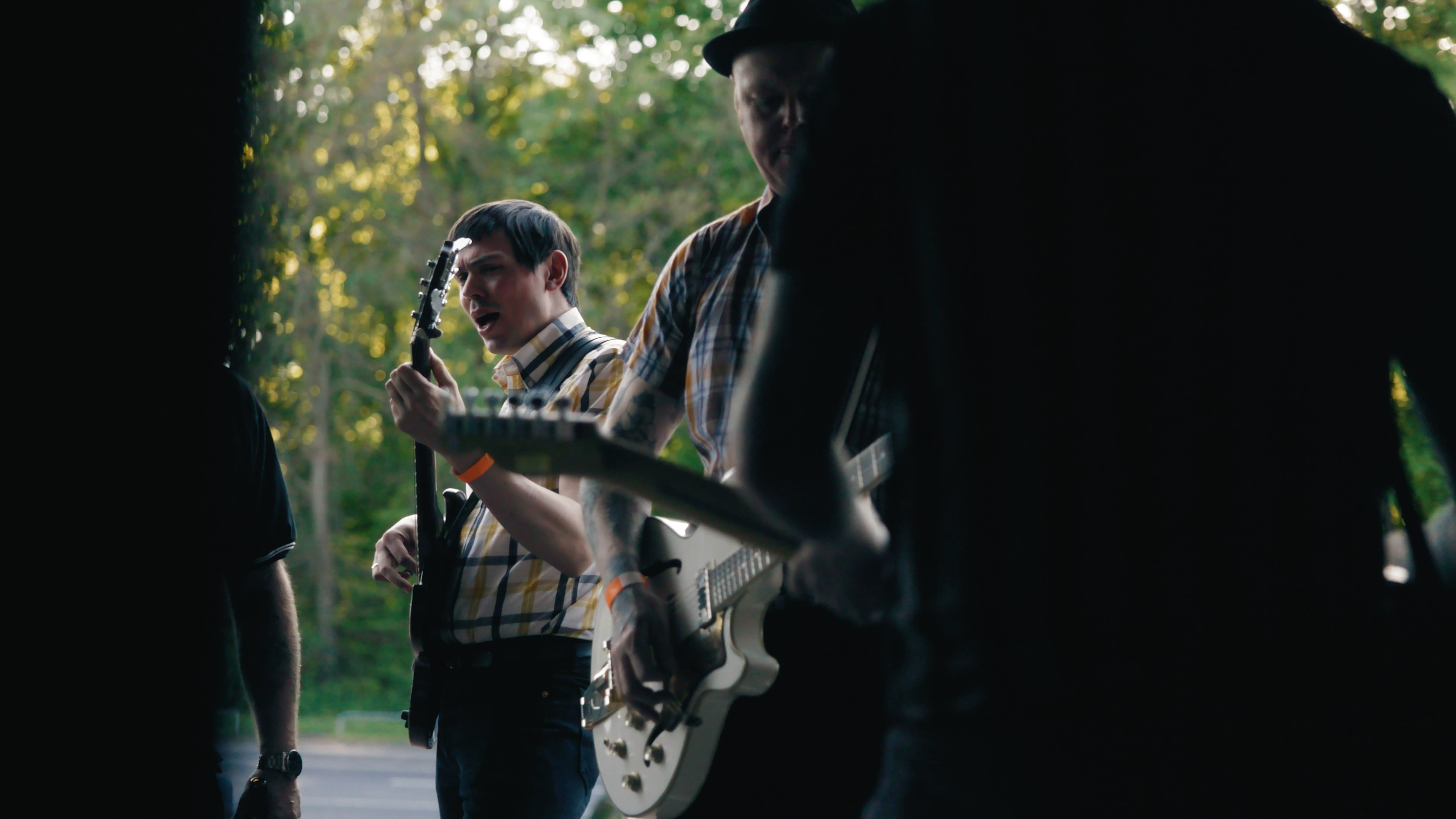 Musicians playing outdoors beside the festival venue