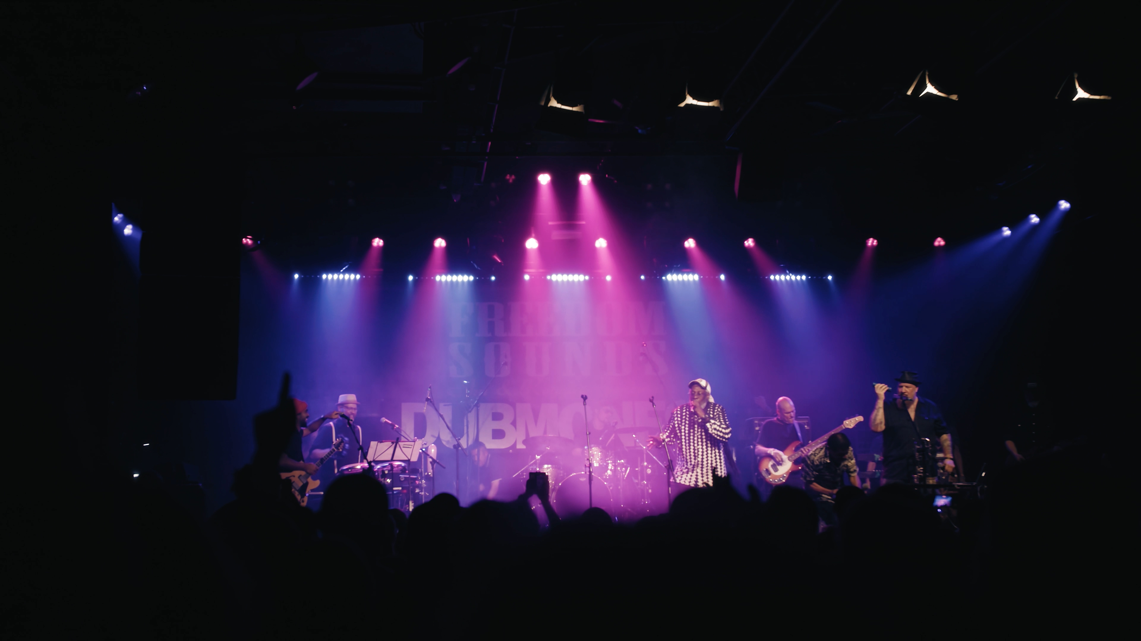 Festival stage and crowd in purple concert lighting