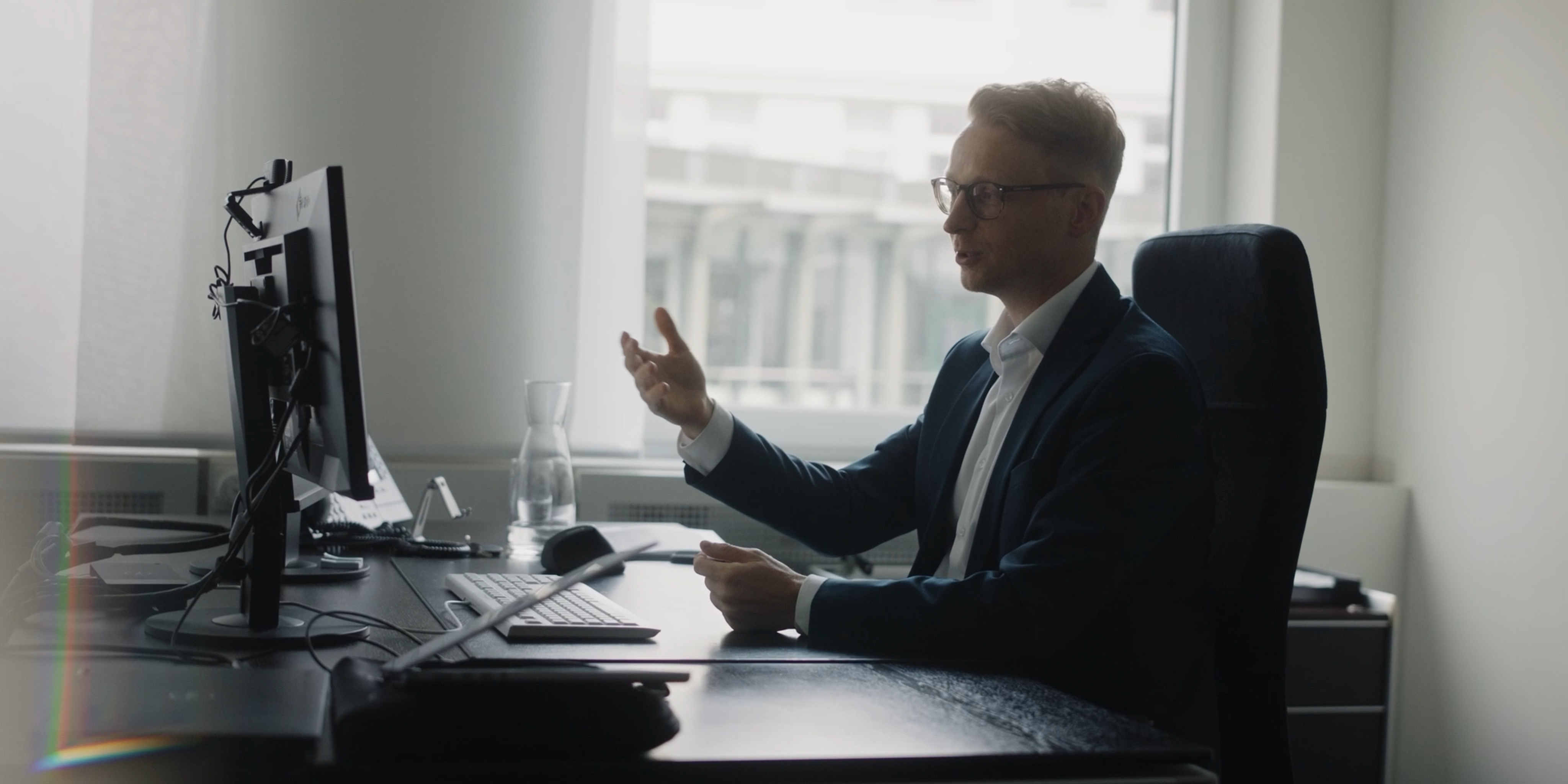 Man working at a desk in a bright office